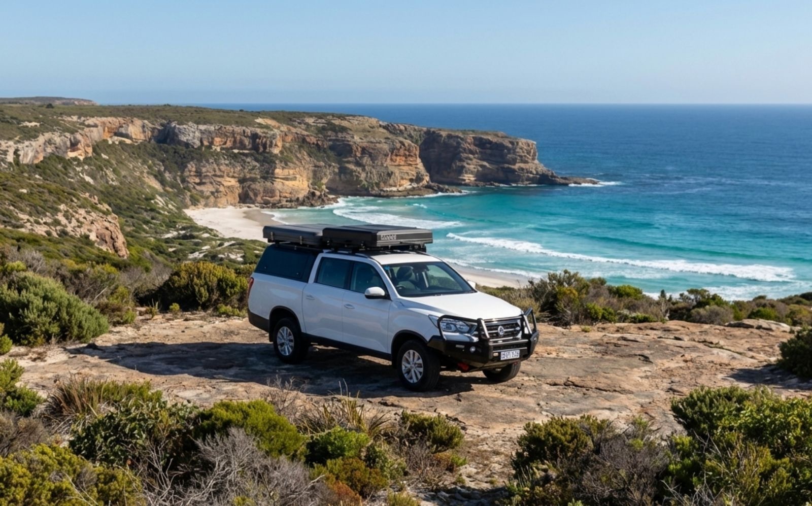 Bakkie 2.0 4WD with dual hard-shell rooftop tents set up at camp